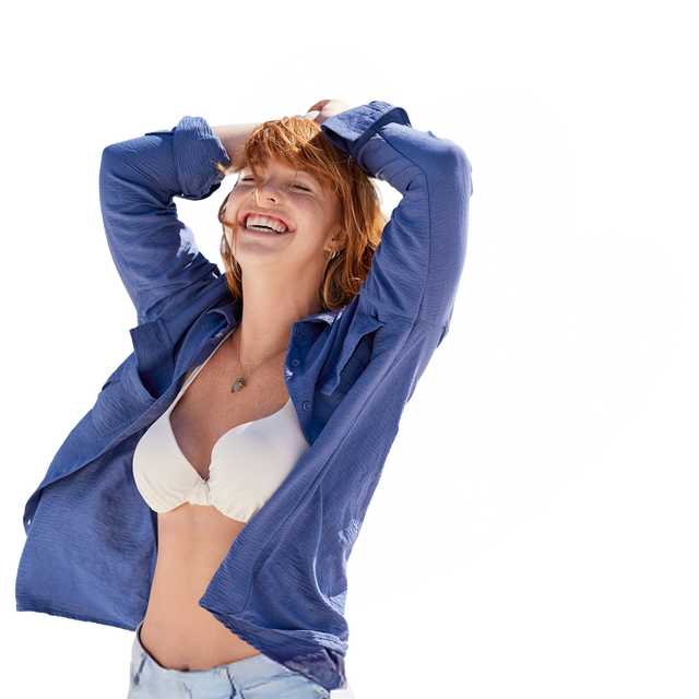 Woman wearing a blue shirt over a white bra on a white background